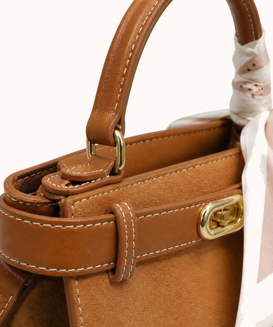 ARIPPULA FEF9F6 | camel-suede-top-handle-bag | hardware detail | 112__camel-suede-top-handle-bag__hardware-detail.webp