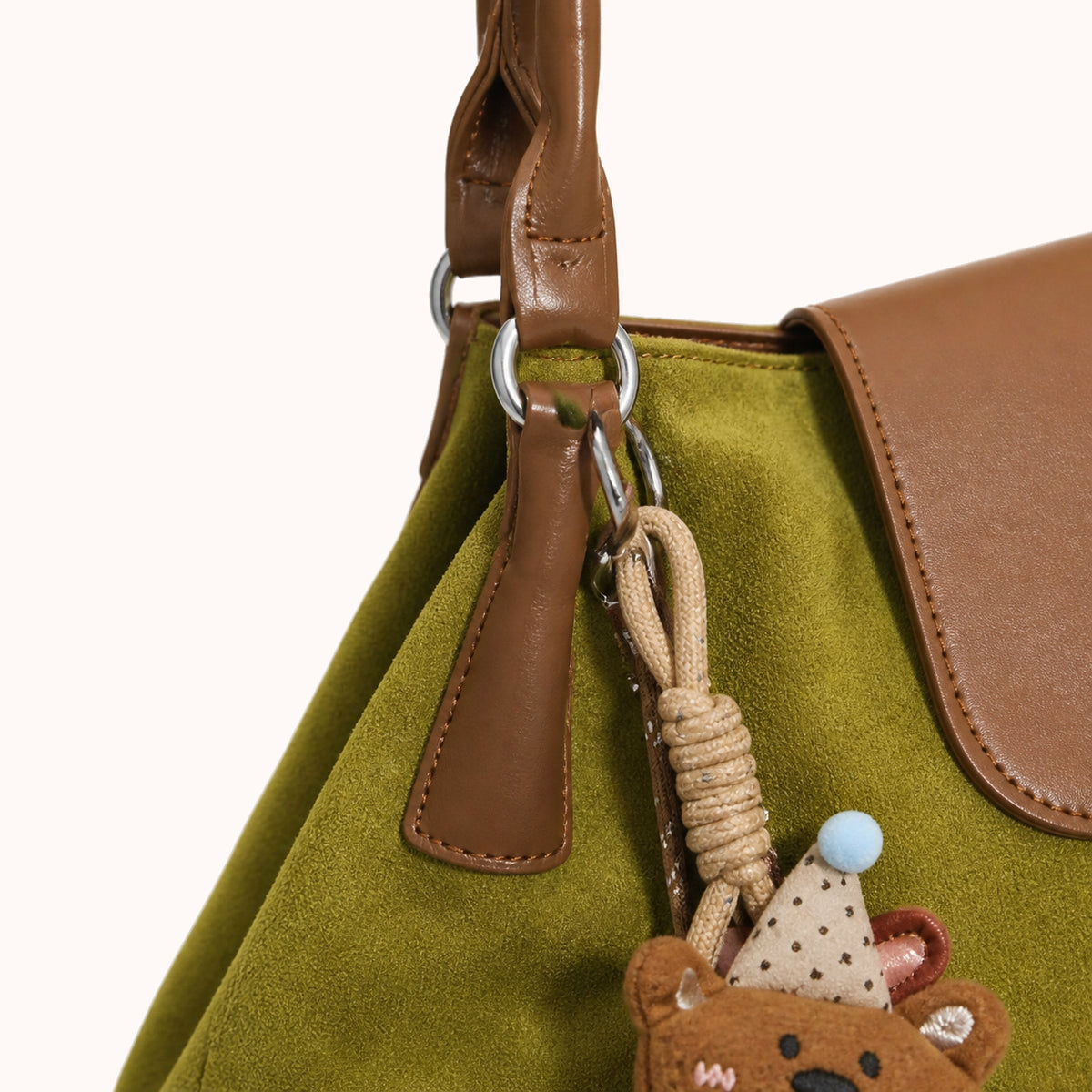 ARIPPULA FEF9F6 | olive-suede-tote | hardware detail | 127__olive-suede-tote__hardware-detail.webp