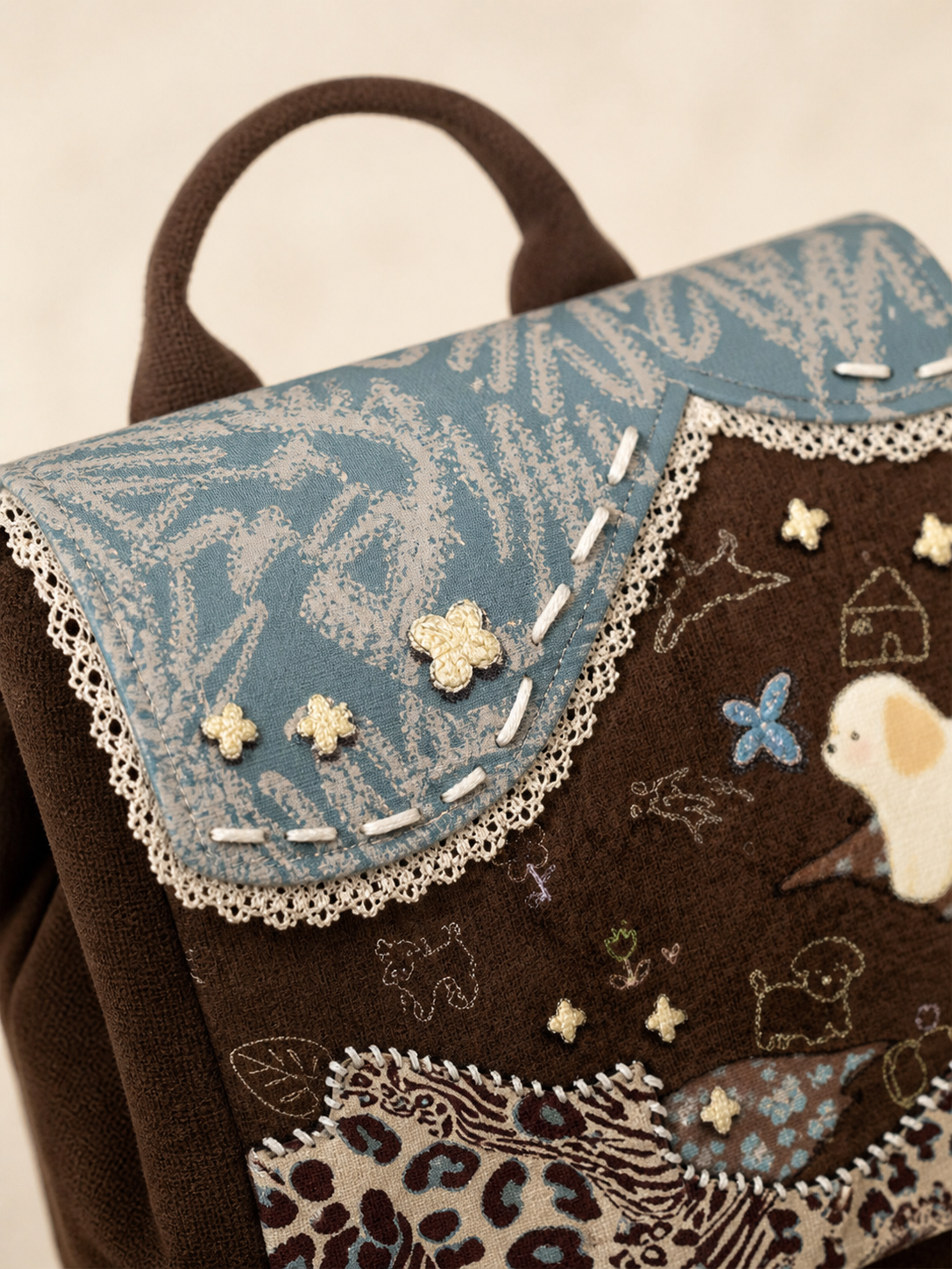 Caramel Puppy Canvas Flap Backpack — flap and lace detail